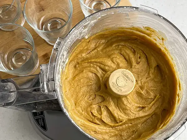 Apricot mousse on food processor with empty glasses