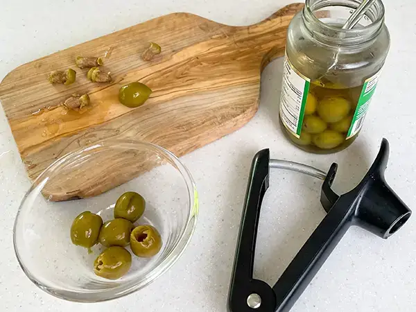 ingredients used in making olivada, green olives, capers, oilve oil, lemon juice, chopped parsley