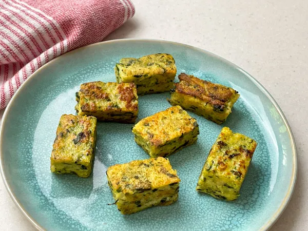 Pieces of golden brown spinach polenta